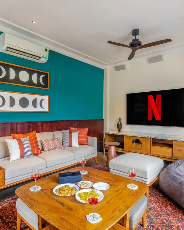 Another angle of this stylish living room, showing how the in-wall speakers and large screen TV are balanced with the room's furniture and art. This proves that high-performance AV can coexist with beautiful interior design.