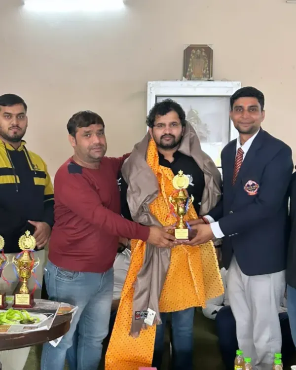 Being felicitated at a local sports event. It is an honor to be recognized by the community.