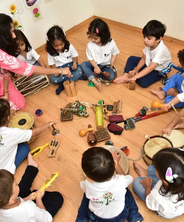 A bird's eye view of our jamming session, where little hands get to explore a variety of Indian percussion instruments. We gather in a circle to share sounds and rhythms, fostering a wonderful sense of community and musical discovery.