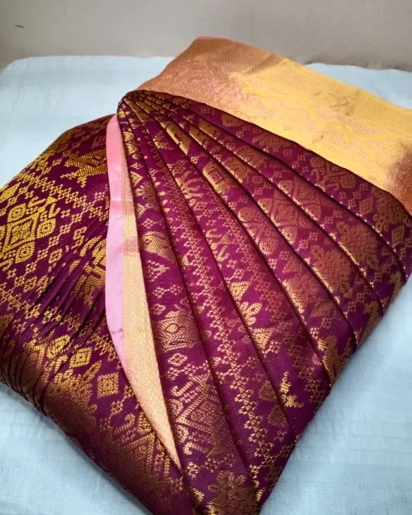 A rich purple and gold Kanjeevaram saree, with its pleats expertly set. The beauty of a silk saree is truly revealed when the pleats are uniform and crisp.
