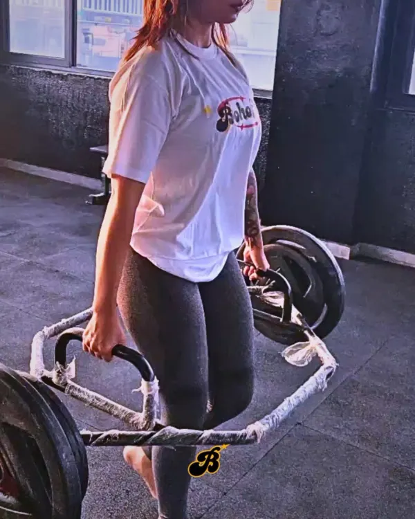 A member performing a hex bar deadlift. This is a fantastic compound movement for building full-body strength and power, safely and effectively.