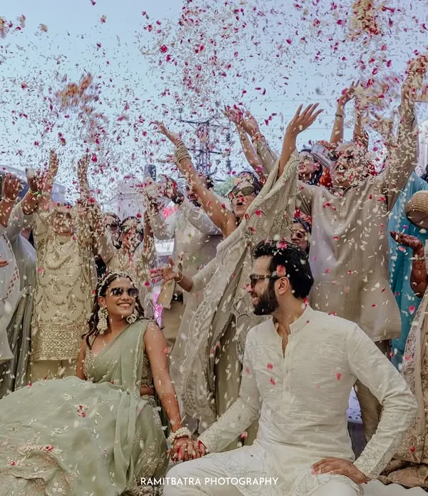 A moment of pure celebration as guests shower the couple with flower petals during their welcome lunch at Fairmont Jaipur.