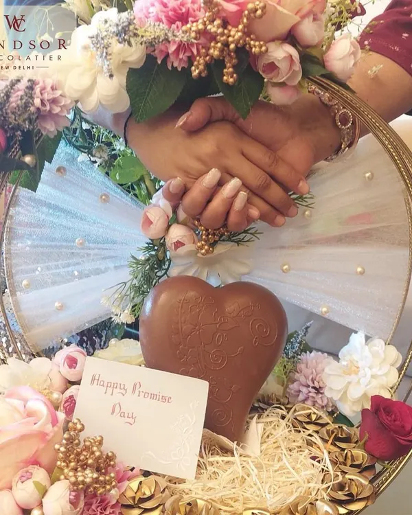 A beautiful Promise Day hamper, featuring a solid milk chocolate heart nestled among flowers and smaller treats, shows how my creations can be part of your most romantic moments.