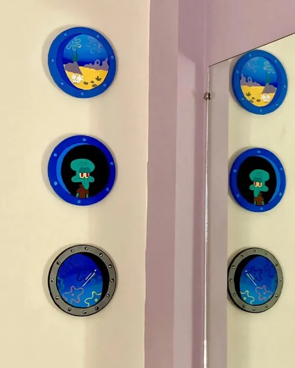 A fun, nostalgic set of Spongebob Squarepants themed wall art. This trio of circular paintings features Bikini Bottom, Squidward, and a guitar, perfect for adding a playful touch to your room.