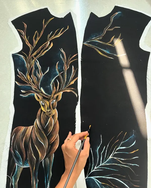Painting this deer on a velvet tuxedo was a challenge I embraced. The design symbolizes change and new beginnings, and I used layers of metallic and earthy tones to create a galaxy-like effect on the rich, dark fabric.