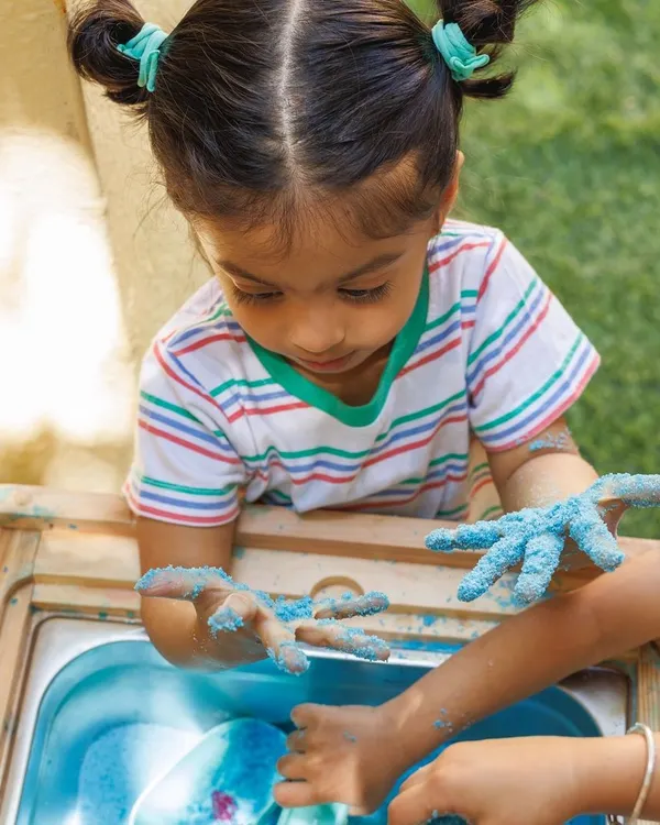 A perfect moment of sensory exploration. Activities like these are designed to be completely child-led, allowing them to explore textures and materials at their own pace, which is essential for fostering curiosity and building confidence.