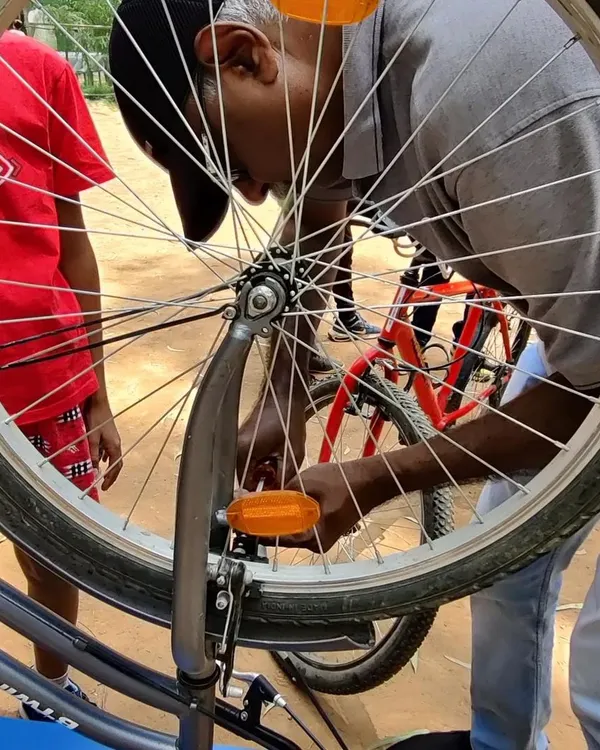 A close-up of a bicycle wheel being serviced at our workshop. We teach the fundamentals of bike maintenance, helping you keep your ride smooth and safe.