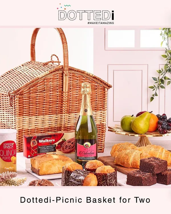 My Dottedi Picnic Basket for Two. This curated hamper includes a bottle of non-alcoholic champagne, fresh pastries, fruits, and other gourmet treats, all packed in a beautiful wicker basket.