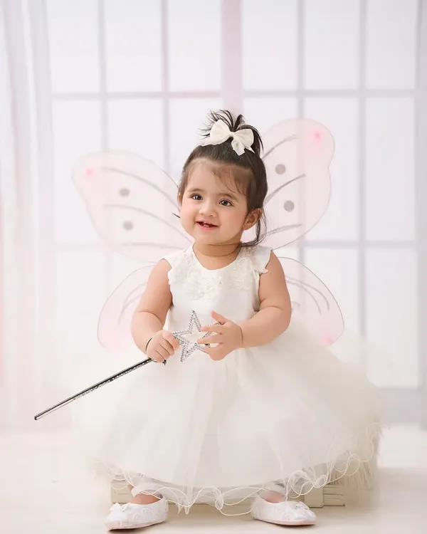 A little fairy in the making. Our studio is stocked with whimsical costumes and props like these wings and wand to create truly magical portraits.