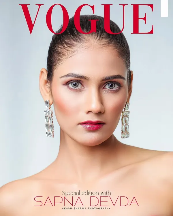 A clean, striking beauty shot that could grace any VOGUE cover. The focus is on the model's flawless makeup and captivating eyes, framed by elegant diamond earrings.
