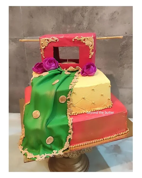 This three-tier Haldi theme cake is designed to look like a traditional dholki and draped fabric. The vibrant green, yellow, and red colors, along with gold detailing, make it a perfect centerpiece for the ceremony.