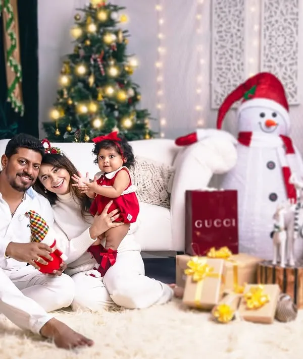 The best gift around the Christmas tree is a happy family wrapped up in each other. A beautiful family portrait radiating warmth and joy.