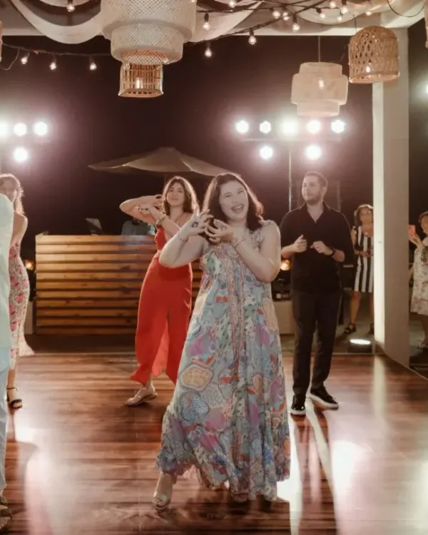 The bride's tribe takes the stage. This photo captures the energy of a group performance we choreographed for a destination wedding in Goa, where we blended different cultural music for a unique show.