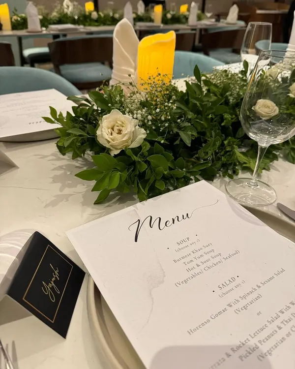 A close-up of a place setting from one of our elegant dinners. We provide custom-printed menus and personalized name cards that perfectly match the event's theme, adding a thoughtful and bespoke touch for every guest.