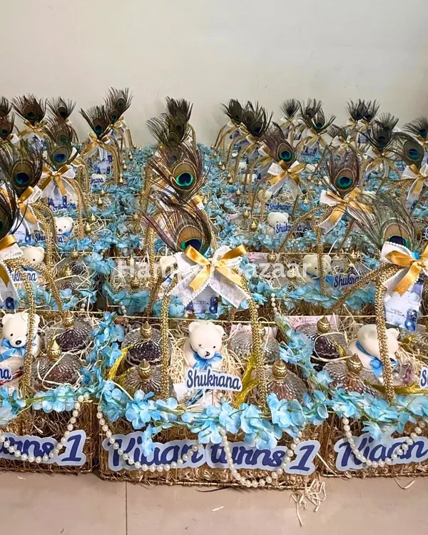 A beautiful display of our 'Shukrana' hampers, designed with peacock feathers and Guruji's blessings for a first birthday.