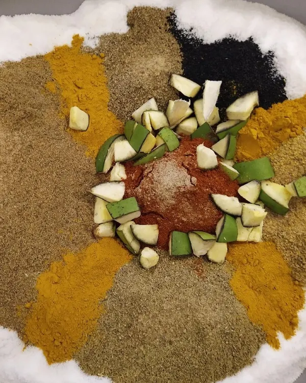 This is where the magic begins. I use a vibrant mix of freshly ground spices and raw, sun-kissed mangoes for my traditional Aam ka Achaar. It’s my mother’s recipe, made with patience and a lot of love, ensuring every bite has that authentic, homemade flavour.