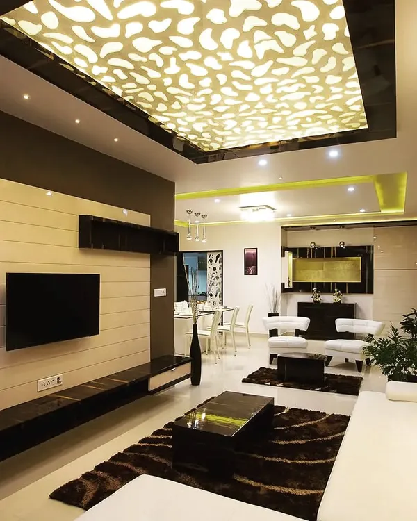 A look at a modern living room we designed, featuring a custom backlit ceiling with an organic pattern that creates a stunning focal point. The design integrates layered lighting and a sleek, built-in media wall to combine luxury with everyday function.