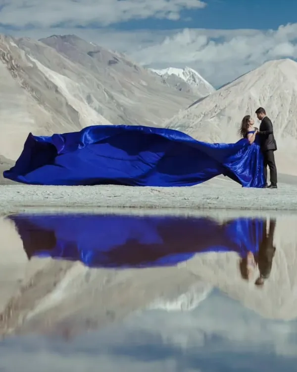 This is what pre-wedding dreams are made of. My royal blue infinity trail gown creates a stunning contrast against the serene mountain landscape, perfect for a truly epic destination photoshoot.