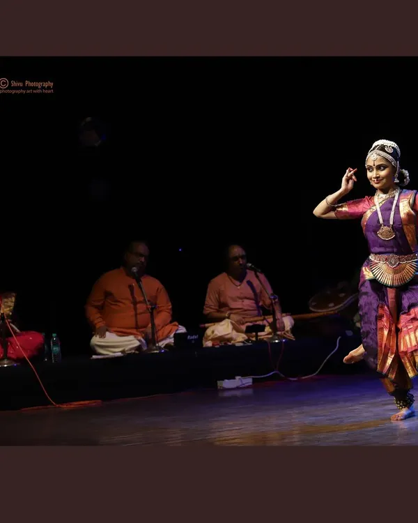 A wide shot of a performance, showing the essential connection between me and the live music ensemble that accompanies every recital.
