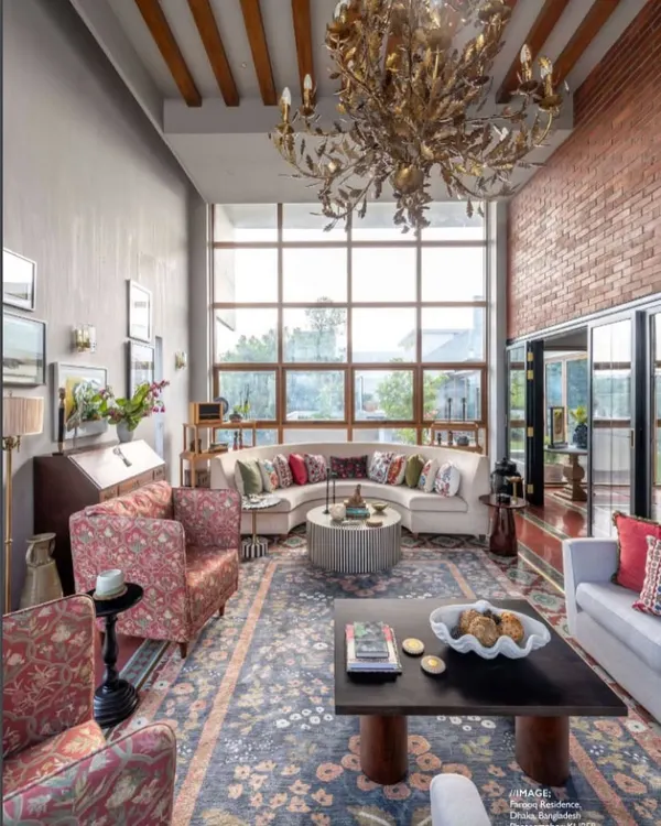 This living room in Dhaka is a conversation between scale and intimacy. We flooded the double-height space with natural light through vast windows, creating an airy sanctuary that still feels warm and grounded. The design blends exposed brick, a dramatic custom chandelier, and a curated mix of contemporary and classic furniture to reflect a well-traveled, soulful life.