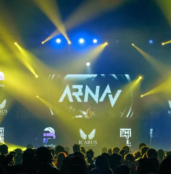 This is the view from the crowd at a major concert at Nesco, Mumbai. I thrive on this scale, with full stage production, massive LED screens displaying my name, and a sea of people ready for a high-energy show.
