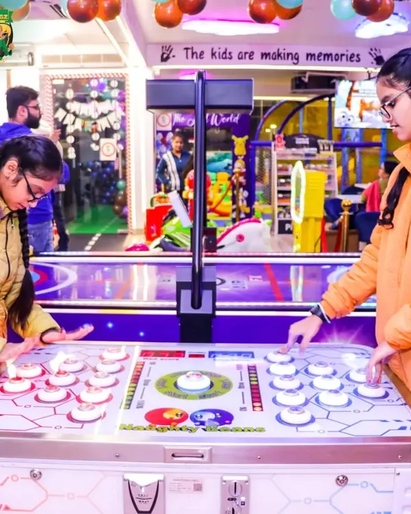 A great action shot of two older kids intensely focused on a fast-paced tabletop arcade game. It's proof that the fun here isn't just for toddlers.