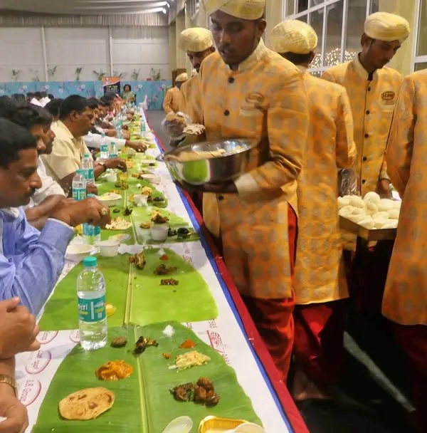 This is the heart of my service, the traditional ela sadya. Here you can see my uniformed team serving guests in a classic pangat setup, ensuring every person feels cared for during the wedding feast.