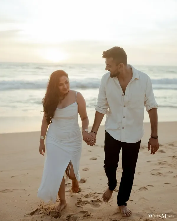 A candid shot of Nidhi and Ruchit walking along the beach in Goa. Their natural interaction and the soft evening light make this a perfect example of a relaxed and authentic pre-wedding photo.
