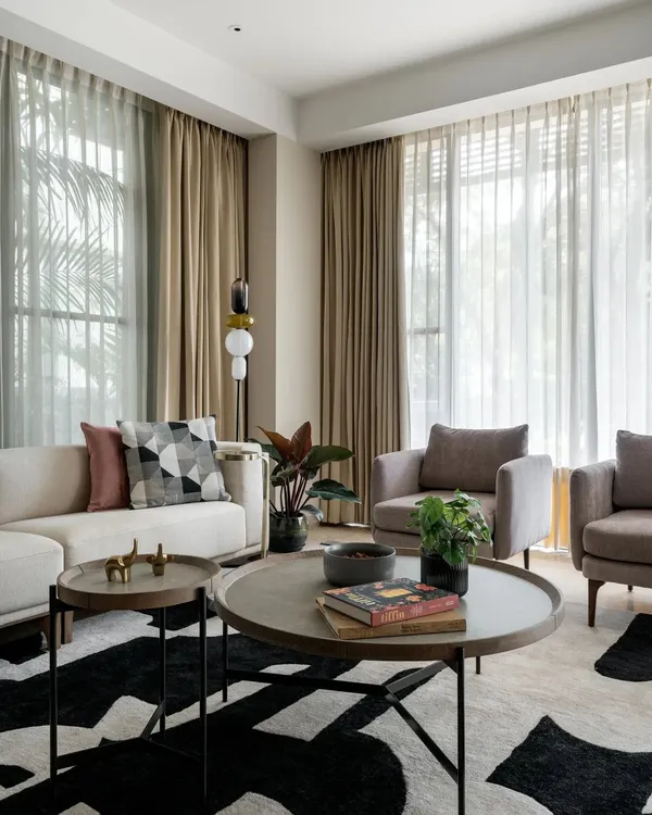 In the living room of Villa 93, we created a sanctuary of calm with a neutral color palette and abundant natural light. The design marries modern furniture with a bold, graphic rug, creating a space that is both sophisticated for entertaining and comfortable for quiet family moments.