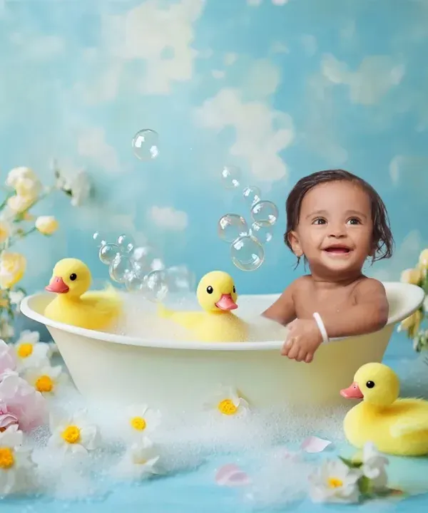 A delightful and fun "bubble bath" splash session in the studio. This theme uses a tub, rubber ducks, and a floral setup to create adorable and playful photos.