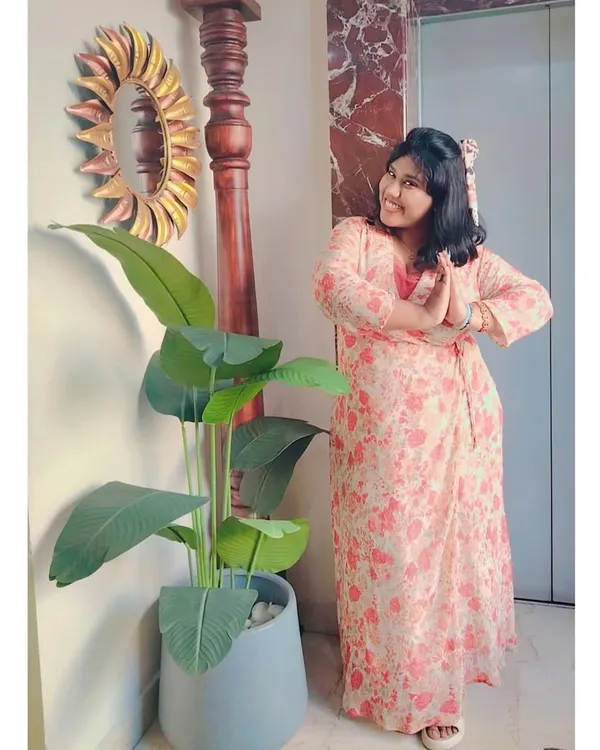 A casual pose in a lovely floral dress. Ready to welcome guests with a traditional "vanakkam".