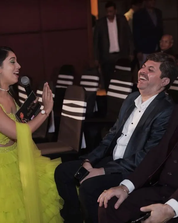 My ultimate goal is to spread smiles. This candid shot captures a moment of pure laughter with guests, which is the most rewarding part of my job as an event host.