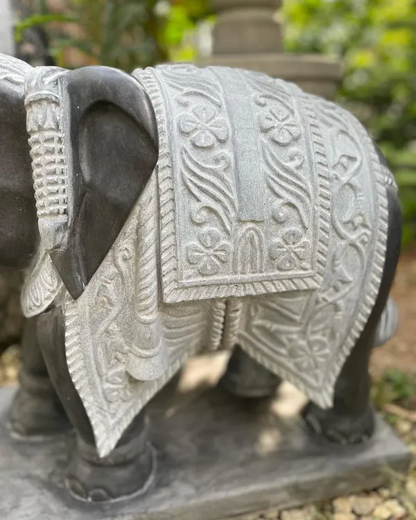 A close-up of the intricately carved blanket on one of our grand elephant statues, showcasing the detailed handiwork of our artisans.