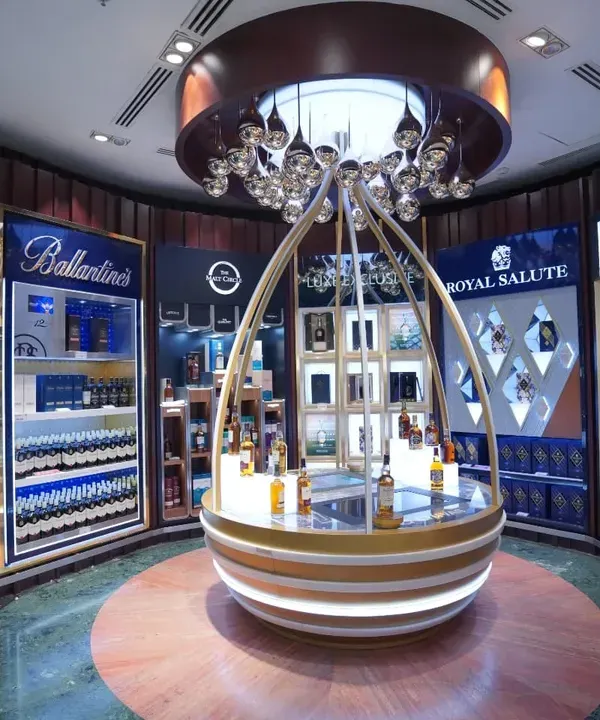 We specialize in creating luxurious and inviting atmospheres for high-end retail spaces. This shot for a premium liquor section at Adani's duty-free highlights the sophisticated product display and ambient lighting, key elements in retail interior photography.