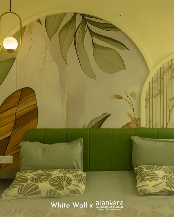 This bedroom features a custom-arched wall mural with a soft, botanical theme. The vibrant green upholstered headboard provides a beautiful contrast, creating a fresh and serene sleeping environment.