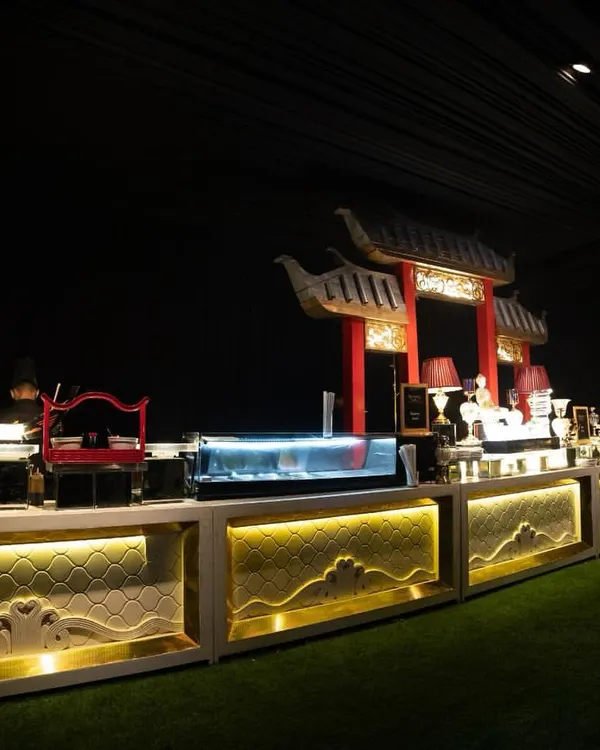 Our grand Pan-Asian buffet setup, complete with pagoda-style architectural elements and dramatic lighting. This station is designed to transport guests, offering an immersive experience into the world of Asian cuisine.