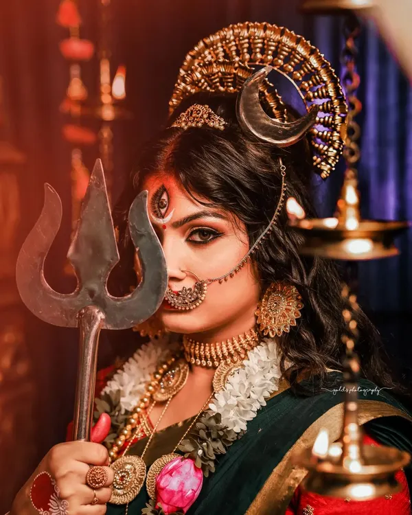 This is a powerful close-up from a conceptual shoot portraying the divine goddess. I focused on creating an intense, direct gaze, using dramatic lighting and traditional makeup to capture a sense of strength and mystique. This type of creative portraiture is perfect for clients wanting to make a bold statement.