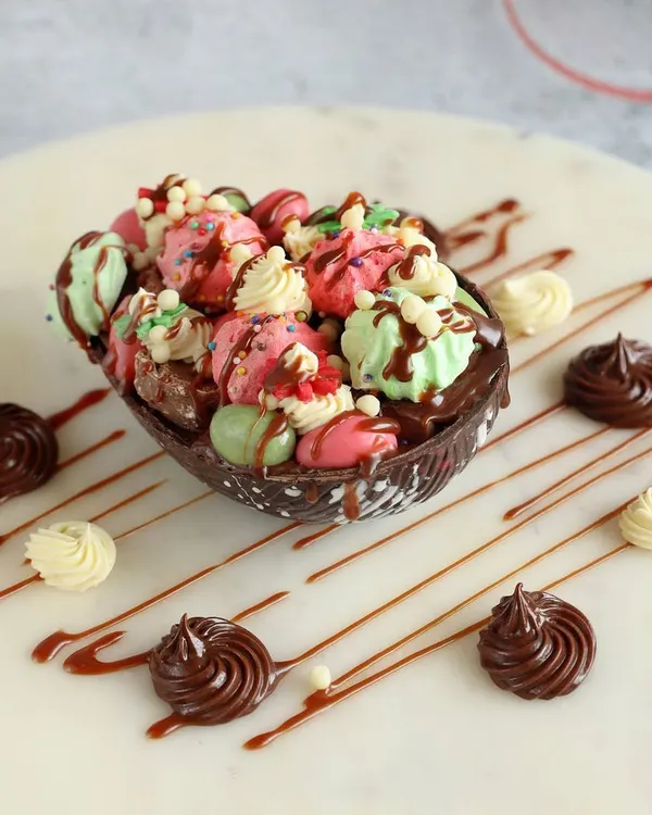 My smashable Easter egg is a fun and decadent treat. The large chocolate egg shell is filled with mini macarons, meringues, and other small sweets, making for a delightful surprise.