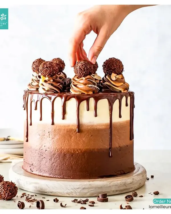 This is for the ultimate chocolate lover. My triple-layer chocolate ombre cake features varying shades of chocolate frosting, a decadent dark chocolate drip, and is topped with Ferrero Rocher truffles and delicate chocolate swirls.