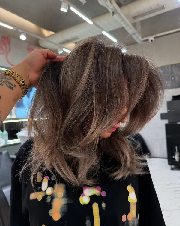 A beautiful blonde transformation with lots of volume and cool, ashy undertones. This look is modern, chic, and full of movement.