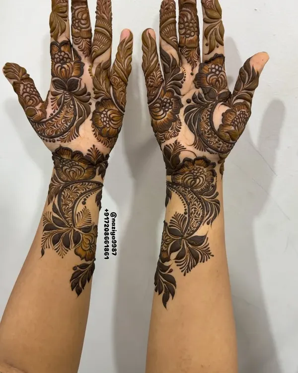 A perfectly symmetrical and intricate henna design covering both hands. This style is popular for important guests who want a full, traditional look with detailed floral and paisley patterns.