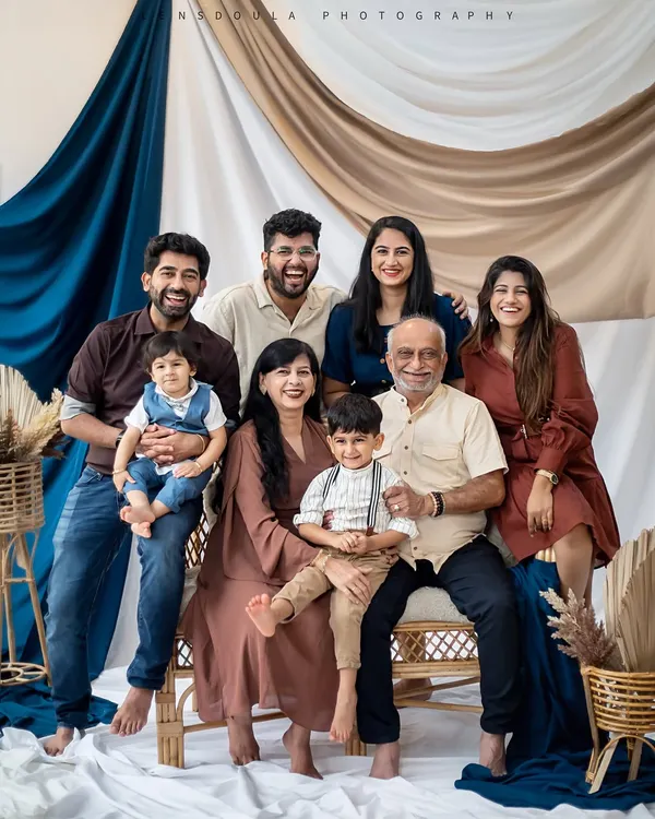 A beautiful, happy portrait of three generations together. I ensure everyone feels comfortable so we can capture genuine smiles and interactions in a classic studio setting.