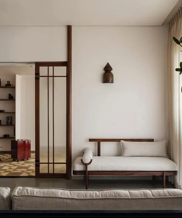 In Apartment 1005, we designed distinct but connected enclaves. This view shows the seamless transition from the bar and living area to the study, using architectural framing and consistent materiality to create a cohesive family mind map.