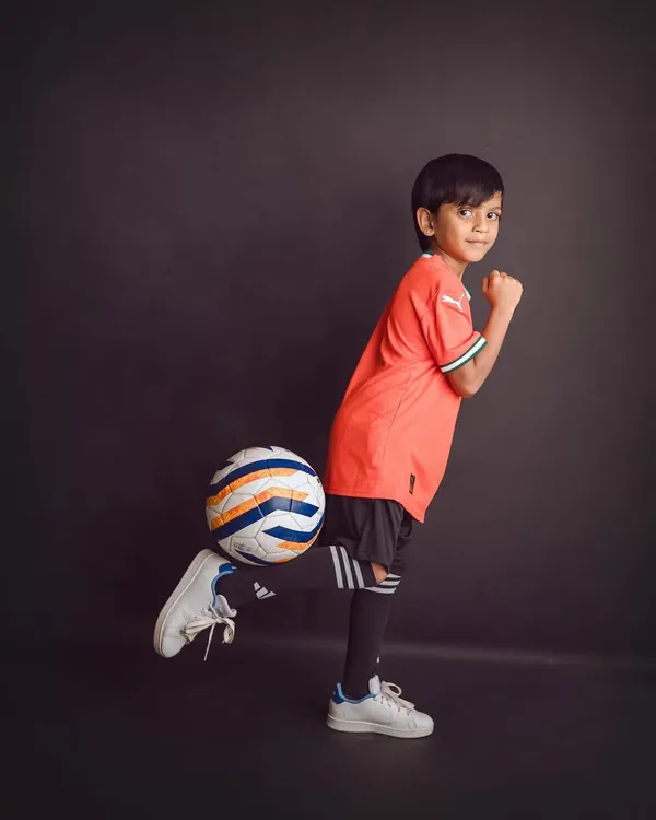 For the little sports star in your family. A simple, dark backdrop makes this young football player and his bright jersey stand out.