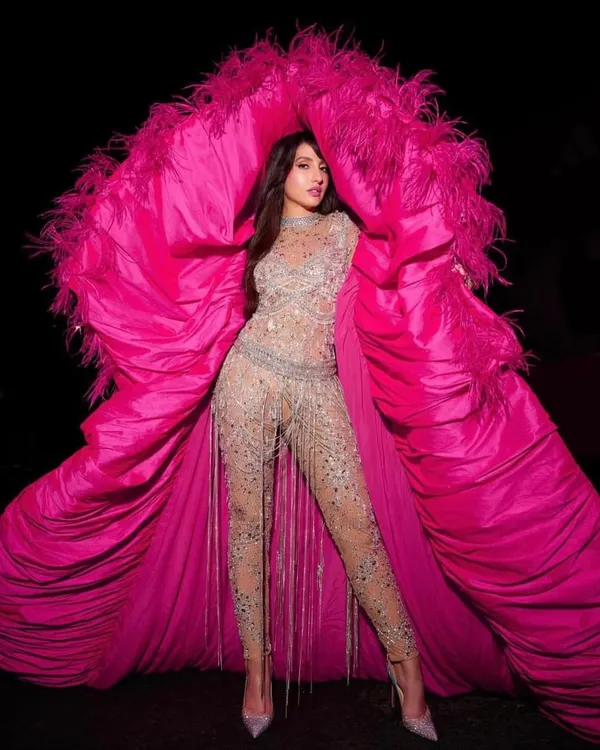For Nora Fatehi's performance at the FIFA World Cup 2022, we created a truly global statement. This custom Falguni Shane Peacock India catsuit, paired with a dramatic feathered cape, was designed to command the stage and capture the energy of the event.