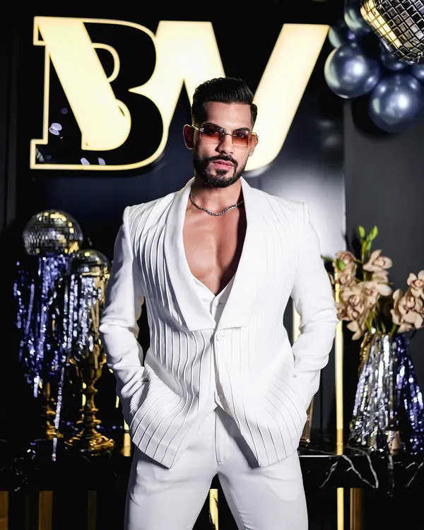 This all-white three-piece suit showcases our dedication to creating bold, personal statements. We crafted this piece with textured fabric and a modern shawl lapel jacket, demonstrating how a bespoke suit can be both powerful and uniquely expressive.