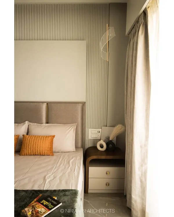 This master bedroom features a serene design with a fluted wall panel behind the bed. The neutral tones and soft fabrics create a calm and restful environment, perfect for unwinding.