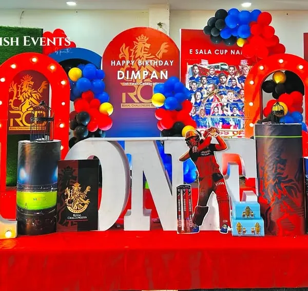 Ee Sala Cup Namde! A full-throttle RCB cricket theme for Dimpan's first birthday, featuring player cutouts, team colors, and a bold 'ONE' display. This entire setup was planned and executed in just one day.