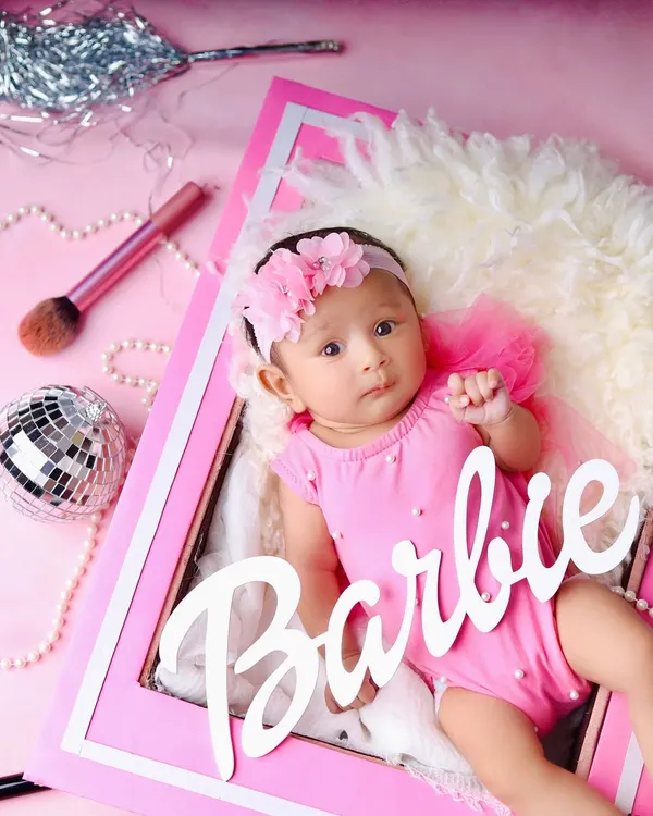 Come on Barbie, let's go party! This adorable baby is ready for her close-up in a fantastic Barbie-themed shoot, complete with a pink frame, a disco ball, and makeup brushes.