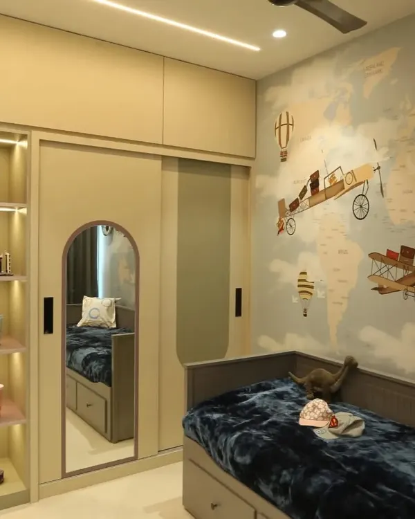 An adventure-themed kid's room, perfect for a young explorer. The world map wallpaper, airplane motifs, and pull-out bed with storage make this room both fun and functional.
